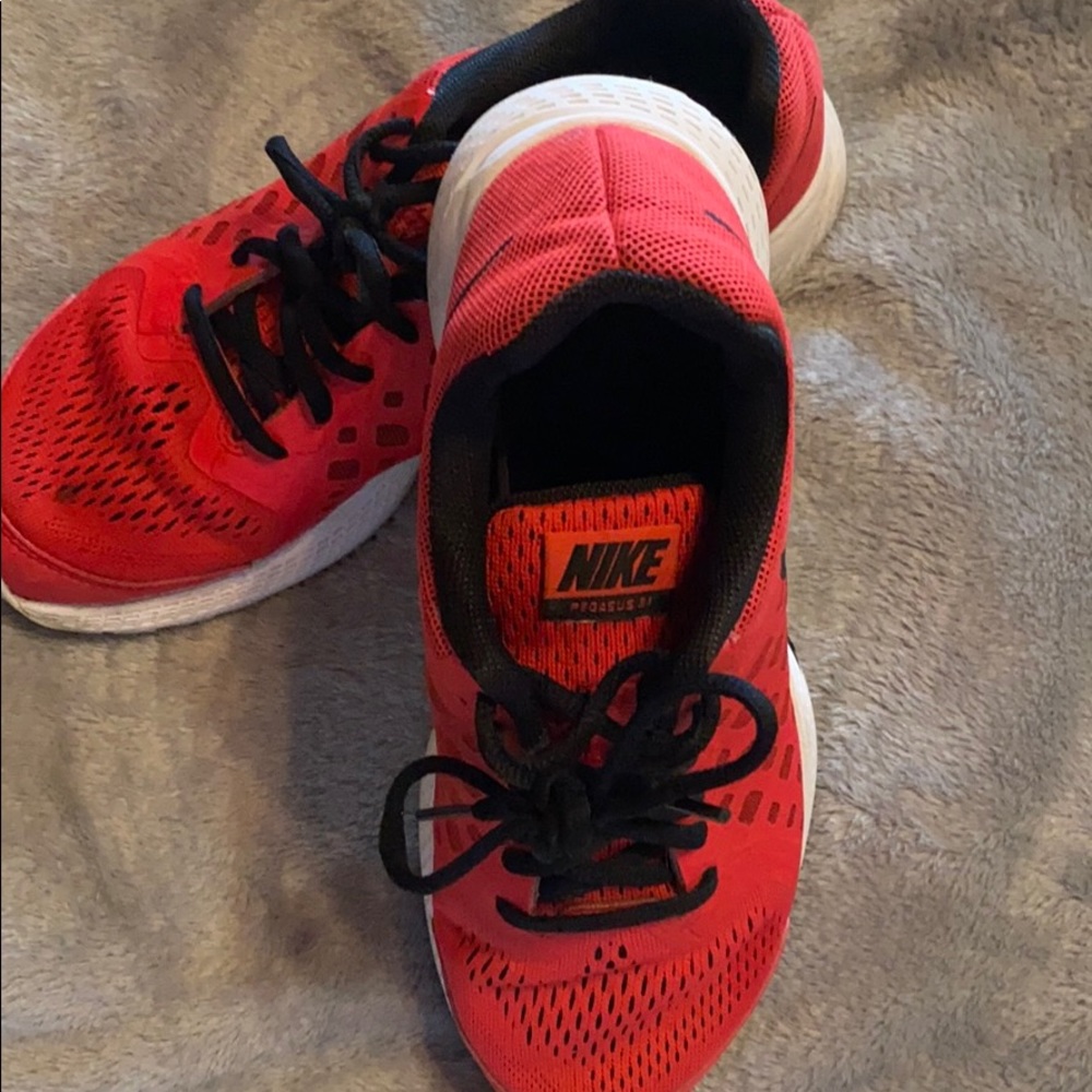 Nike red, black and white shoes for women .